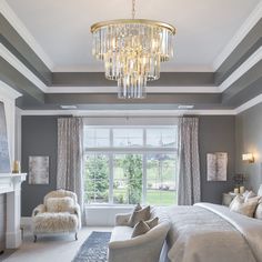 a bedroom with a chandelier hanging from the ceiling