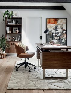 an office with a desk, chair and bookshelf