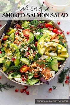 a salad with cucumbers, tomatoes, feta cheese and herbs in a bowl