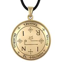 a gold pendant with an inverted symbol on it