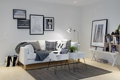 a living room filled with furniture and pictures on the wall