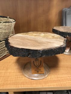 two pieces of wood sitting on top of a wooden table next to wicker baskets