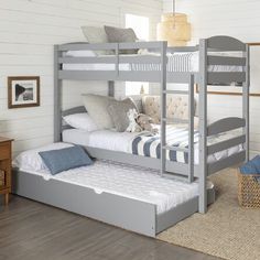 a bunk bed with two sets of mattresses on top of it in a room