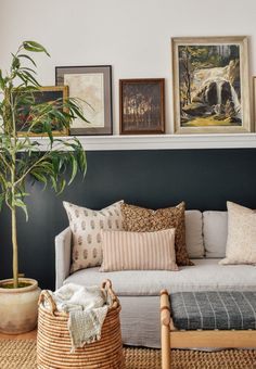 a living room filled with lots of furniture and pictures on the wall above it's couch