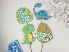 there are three dinosaur cupcake toppers on the sticker is it's boy