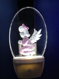 a glass figurine in a circular display case