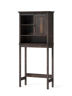 a tall wooden cabinet sitting on top of a white floor next to a black shelf