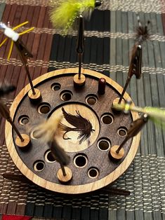 a wooden clock with birds on it sitting on a table