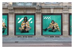 three billboards on the side of a building with people dressed in costumes sitting down