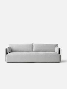 a white couch sitting on top of a gray floor