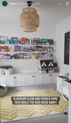 a playroom with lots of toys on the wall and a rug in front of it