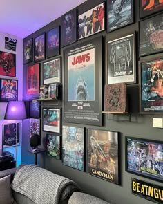 a living room filled with lots of posters on the wall