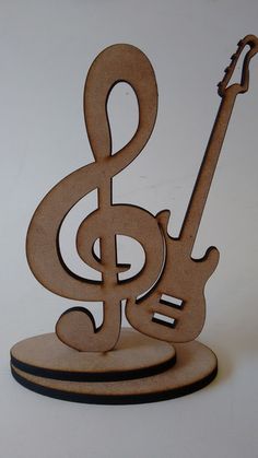 a wooden music note with a guitar on it