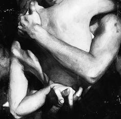 a black and white photo of a naked man with his arm around another person's chest