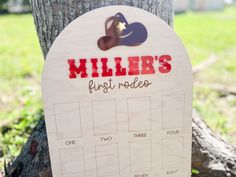 a wooden sign that says miller's first rodeo on it next to a tree