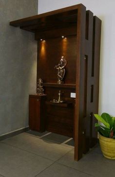 an entry way with two sculptures and a potted plant