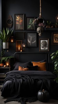 a bedroom with black walls and lots of pictures on the wall, candles lit up in front of the bed