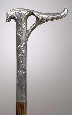 an ornate silver and wood walking stick