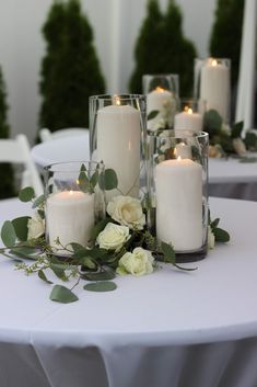 candles and flowers on a white table cloth