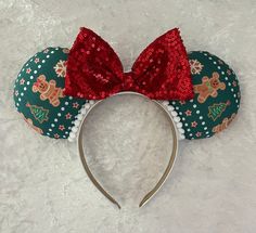 a minnie mouse ears headband with red sequins and reindeer print on it