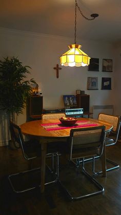 a dining room table with chairs and a laptop on it