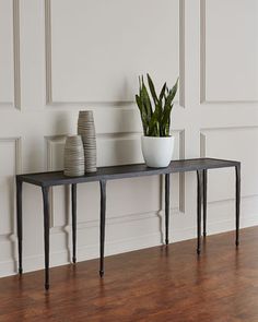 two vases and a plant on a table