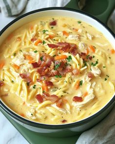 a bowl filled with chicken noodle soup on top of a table