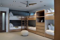 a room with bunk beds and white pillows