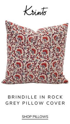 a red and white pillow with the words, brindle in rock grey pillow cover shop