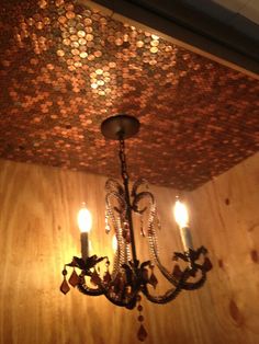 a chandelier hanging from the ceiling in a room with wood paneling and coins