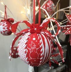 red and white ornaments hanging from a tree