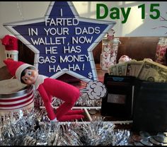 an elf is sitting in front of a sign that says i farted in your dads wallet, now he has gas money ha ha ha ha ha