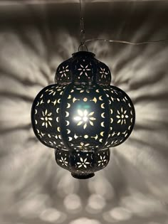 an intricately designed lamp hanging from the ceiling