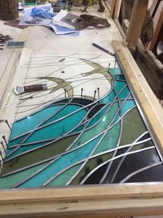 a table that has some kind of stained glass on it and is being worked on