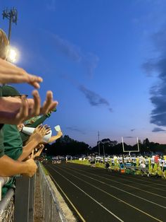 people are lined up in the bleachers to sign autographs for their fans