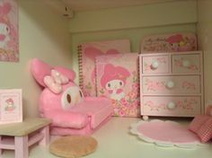 a dollhouse bedroom with hello kitty furniture and accessories on the floor, including a pink teddy bear bed