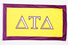 a yellow and purple flag with the letters atta on it's bottom corner