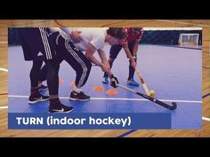 three people playing field hockey on an indoor court with the words turn indoor hockey above them