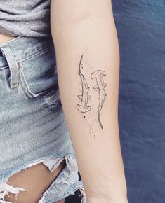 a woman's arm with a small tattoo on the left side of her arm