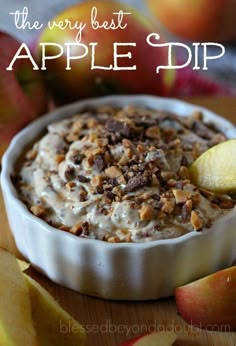 an apple dip in a bowl with apples around it