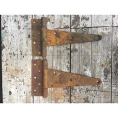 two rusted metal latches on an old wooden door with nails and rivets