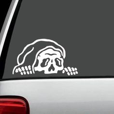 a sticker on the back of a car with a skull