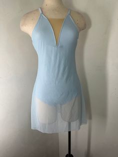 a mannequin wearing a light blue top with white sheers on the sides