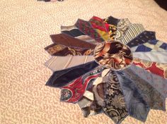 a bunch of ties that are laying on a bed together in the middle of a circle