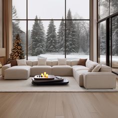 a living room filled with furniture and a christmas tree in front of a large window