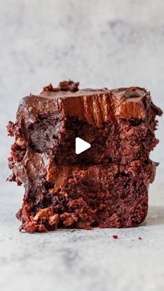 two chocolate brownies stacked on top of each other, with one piece cut out