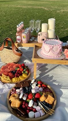 two trays filled with food sitting on top of a white table covered in grass