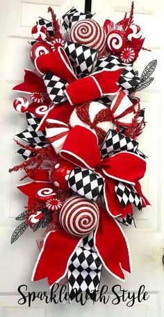 a red and white wreath hanging on the side of a door with candy canes