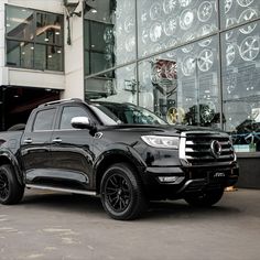 a black truck parked in front of a building