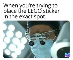 a man wearing glasses and a surgical mask with the caption when you're trying to place the lego sticker in the exact spot